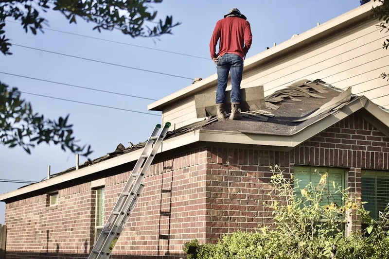 Professional roofer working on a residential roof in Mayberry Village